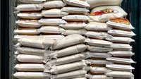 A labourer takes a nap on top of rice-sacks at a market in Jakarta, Indonesia, 5 September 2006