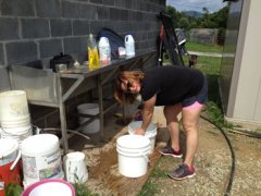 Since the fire, East Coast Exotic Animal Rescue's volunteers do laundry and wash dishes outside using a hose. Here, secretary/treasurer Melissa Bishop washes dishes.